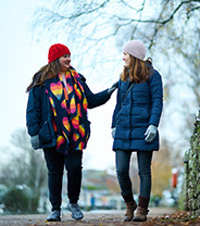 Two women walking in the cold together