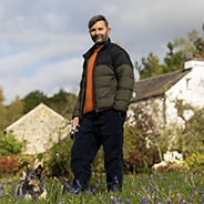 Jeremy standing in a wildflower meadow in a country setting